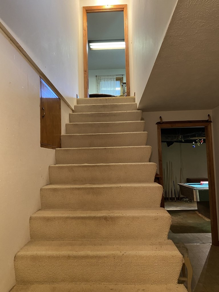 Staircase in dining area leading to basement